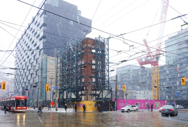 southeast corner of Bathurst and King, vacant lot where most of Banknote Bar was. North facade saved and is held up with scaffolding, now a metrolinx construction site