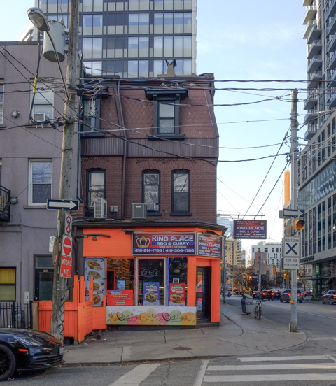 King Place BBQ and Curry restaurant, painted orange, in an old second empire brick building at Dundas and Dalhousie,