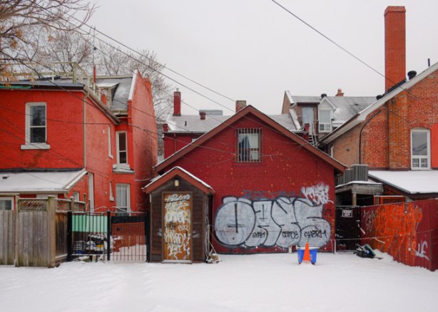 backyards and houses seen from a wintery snowy chinatown laneway