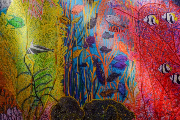 fabric artwork by Pacita Abad hanging at the Art Gallery of Ontario, underwater scene, different types of fish, colourful seaweed, 