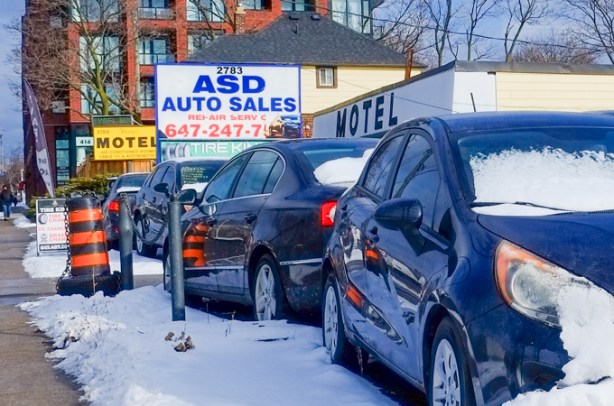 dark blue cars, in snow, parked at used car lot on Kingston Road, ASD Auto sales