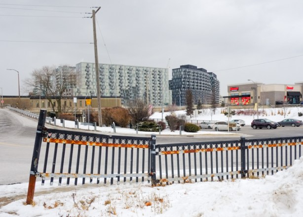 standing in parking lot on west side of wilson station, looking southeast towards allen expressway, retail big box stores on west of allen, new residential highrise on the east side