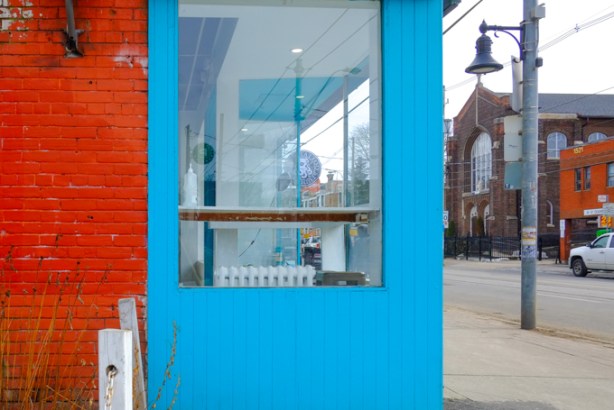outside wall painted bright blue, window, 