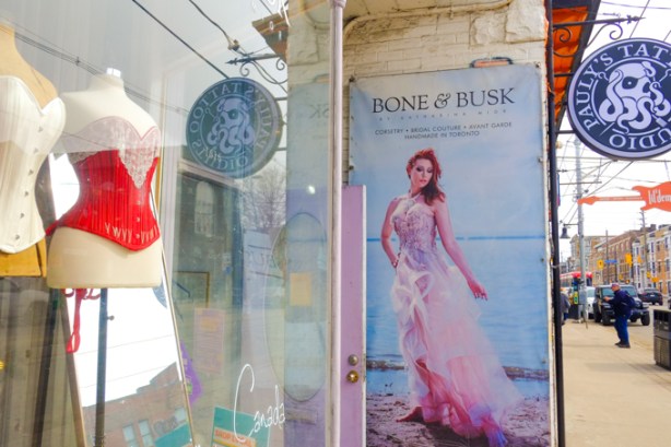 Front window with two corsets, one white, and one red, of bone and busk store on queen west 