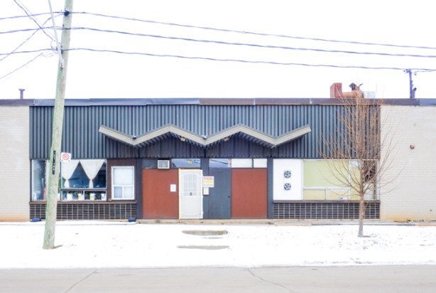 one storey light industrial building in scarborough, with zigzag roof over entrance