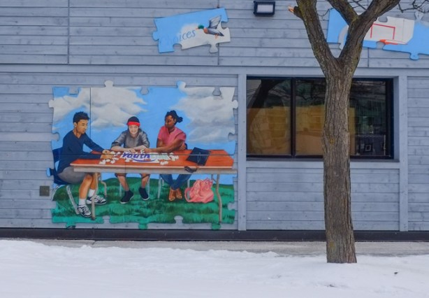 kids playing cards, youth theme murals on low rise building, mural routes