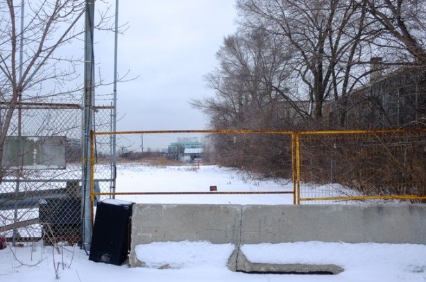 vacant lot with concrete barrier blocking entry