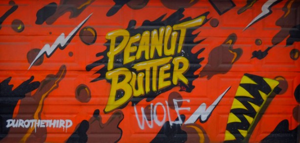 street art on a garage door in an alley, peanut butter, 