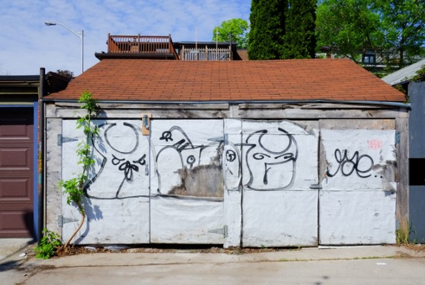 black line drawings on old white garage