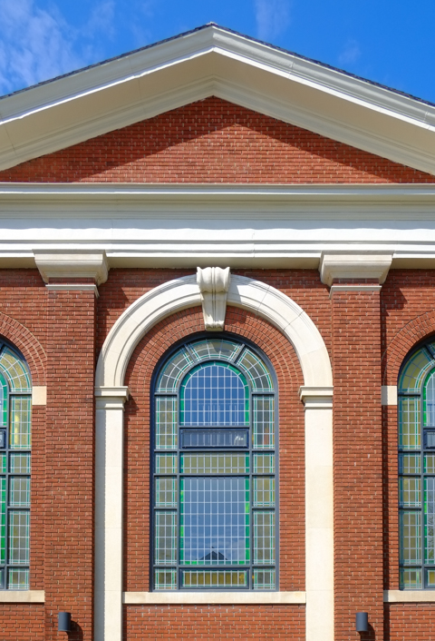 central window, with leaded coloured glass, of the old Temple Baptist Church, now condos, brick building from 1925.