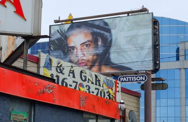 image of young black men, by alanna fields, on a billboard