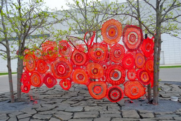 Tracey-Mae Chambers, art installation at Aga Khan museum, outdoors, crochet and knit circles connected together to make a larger circle. 