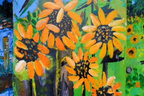 5 large sunflowers in a field of sunflowers, part of a mural of nature scenes by B C Johnson in Gloucester Place