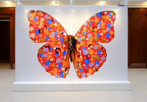 a large image of a butterfly, by Jordan Sook,on display at Union Station
