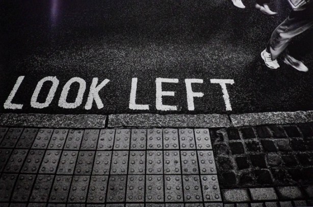 the words look left in capital letters on the pavement by a crossing, warnings to pedestrians crossing the road