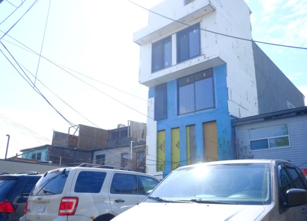 newly renovated house as seen from the alley behind, big new windows, and a new upper level