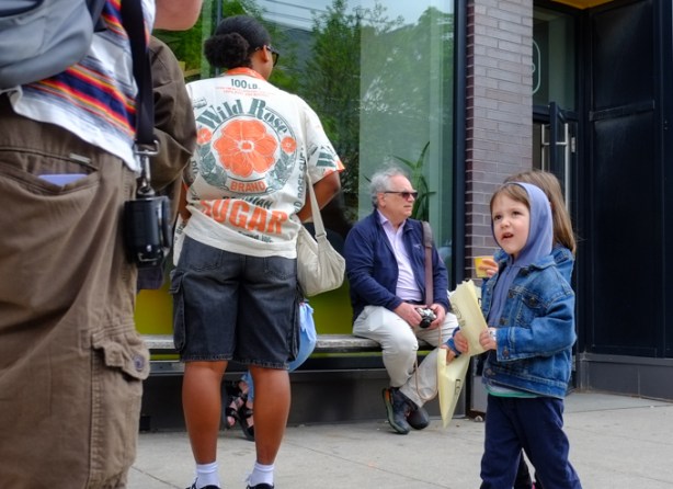 children walking past a group of photographers and giving them strange look