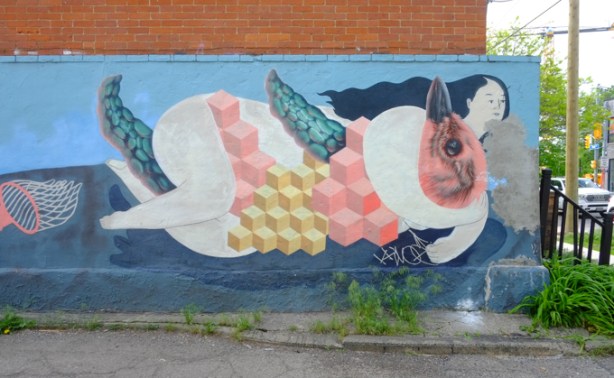 mural by Jerry Rugg, birdo, of a woman and a bird like creature entwined and lying down, in an alley