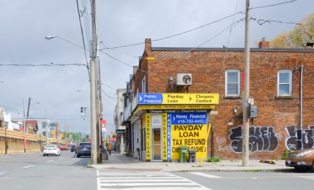 payday loans, signs all over building on pape