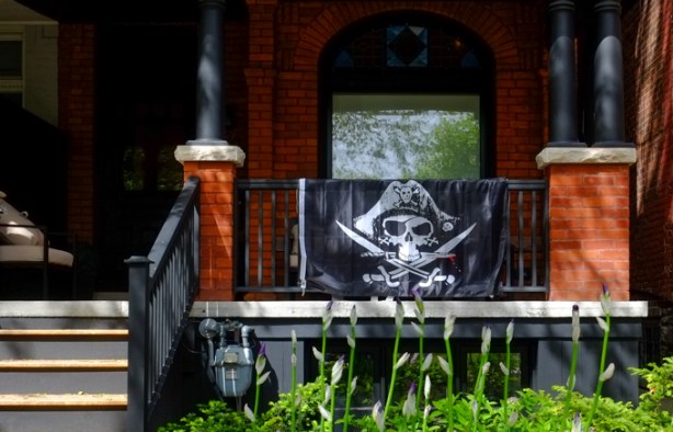 front porch of a house, with a pirate flag on display