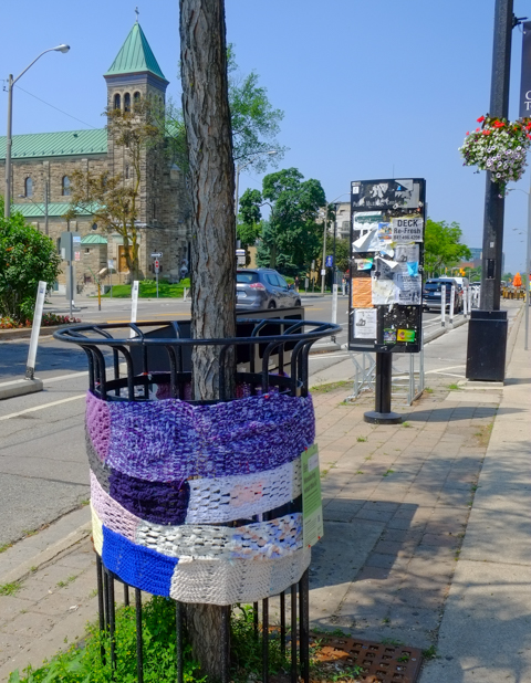 yarn squares encircle a pole on bloor street west