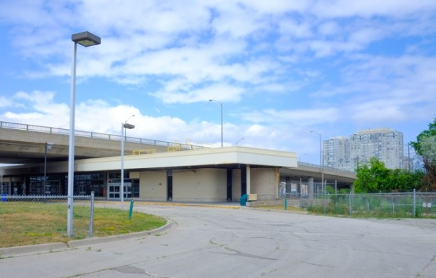 low flat concrete building, Lawrence East station on now defunct SRT line. It is under a bridge, under Lawrence Avenue.