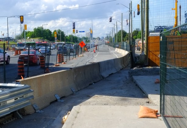 looking north on McCowan at Progress, by old McCowan srt station, concrete barrier narrowing the street, construction on the right