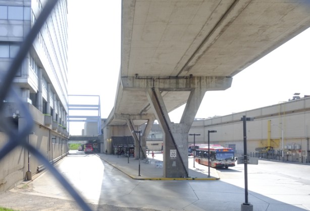 a TTC bus passes by Scarborough Town Centre station with its now abandoned elevated tracks