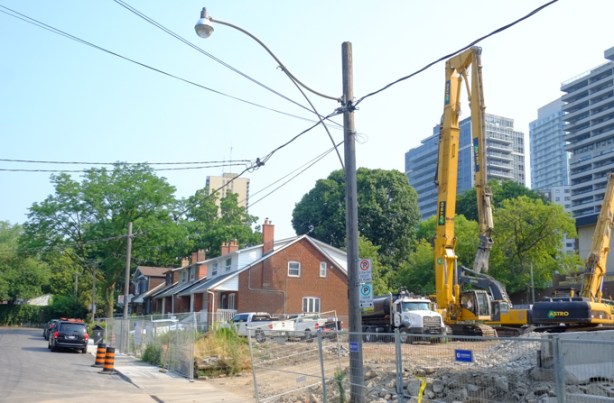 Henning Ave., older single family homes with construction of new condos started beside them, crane, 