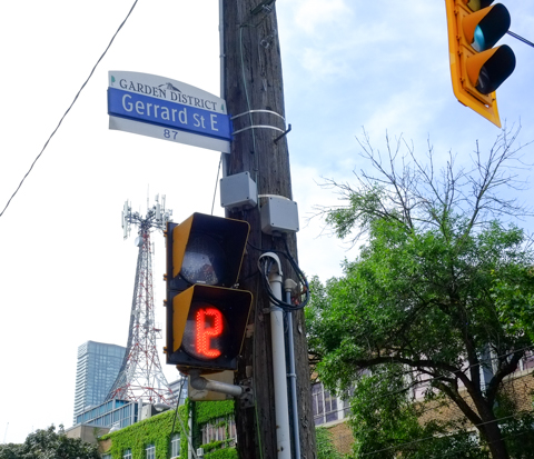 city of toronto steeet sign for Grrard St East, with header that says Garden District