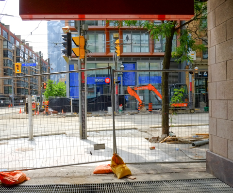 at king and church, construction fence, on west side of church, looking at southwest corner of the intersection BMO bank