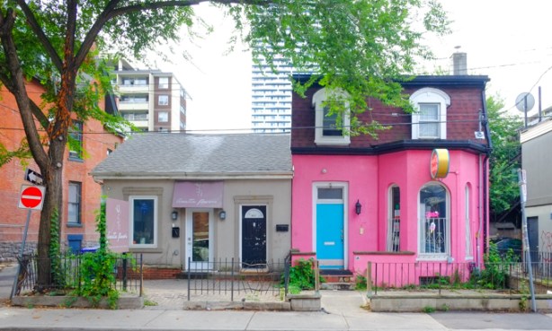 old houses on Maitland street, now stores and businesses, one is painted bright pink with a turquoise door