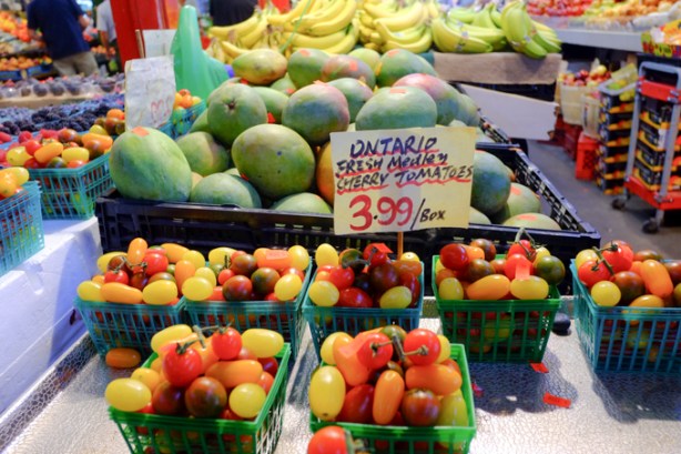 red, yellow, and orange cherry tomatoes, grown in Ontario, for sale, also some mangos and bananas, saint lawrence market