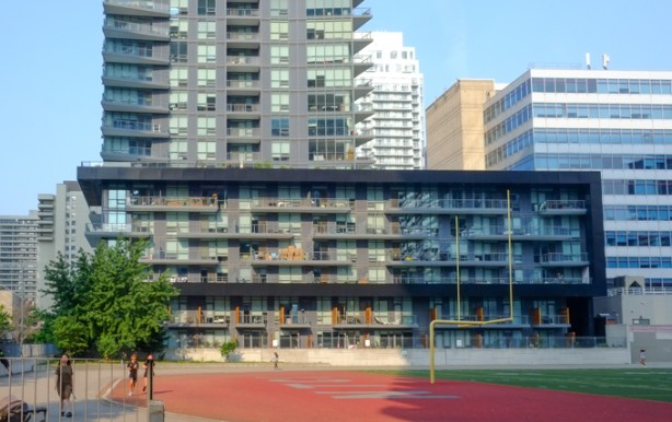 view west from football field and track, partof North Toronto Collegiate, many tall condos