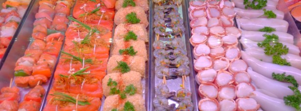 display case full of raw fish for sale, salmon, shrimp, and others, at fishmonger, st. lawrence market