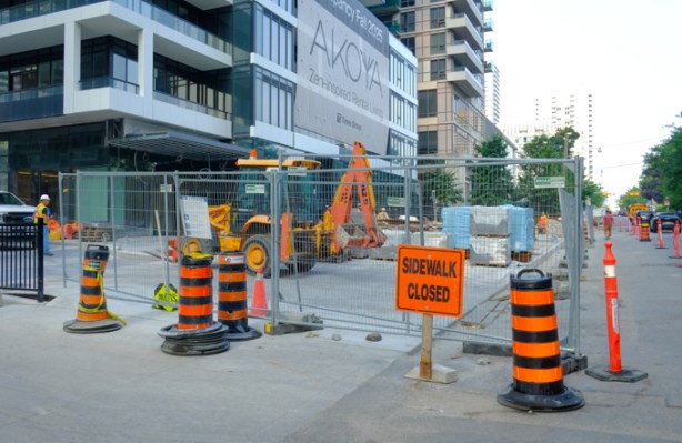 sidewalk closed in front of Akoya, new condo on Broadway, as they finish work on the front entrance and landscaping of the building