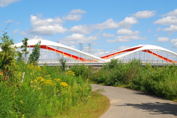 walking and biking path through biidaasige park towards red bridge on commissioners street