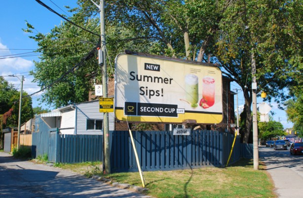 a large billboard on Eastern avenue, with advert for second cup coffee shop, summer drinks