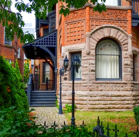 old lamp posts by a brick building