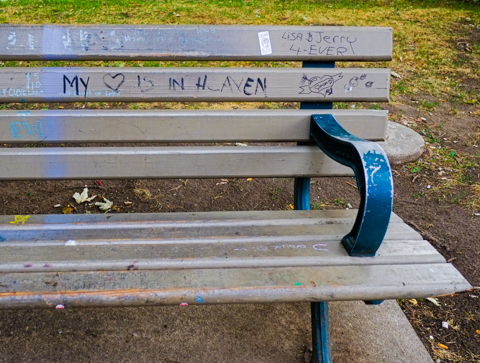 wood park bench with graffiti, words that say my heart is in heaven, also Lisa and Jerry 4 ever