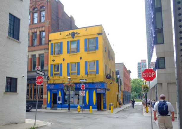 front of O'Briens tavern, Leader Lane and Colborne street, an old yellow buolding with blue trim