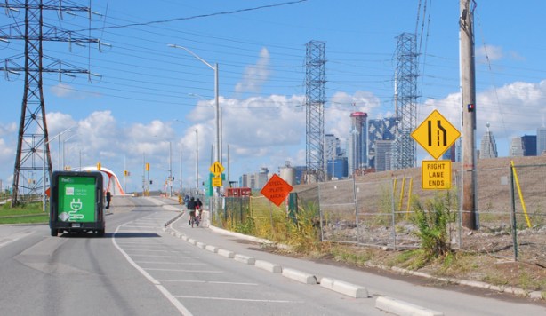 a cyclist rides on Commissioners street in the port lands