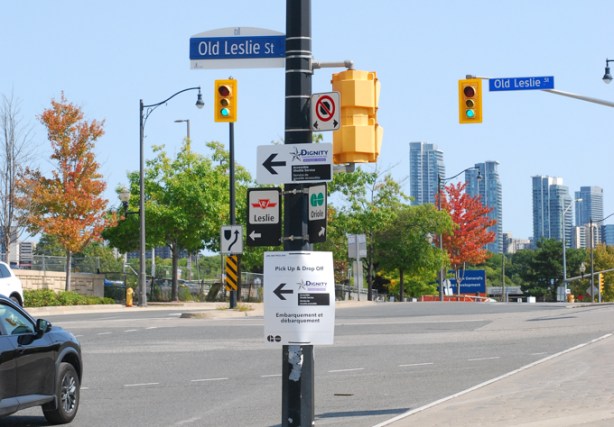 Old Leslie Street sign on post along with other signs for TTC and GO,