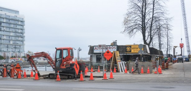 Alexandros fast food Greek style on the waterfront, with construction cones and equipment around it.