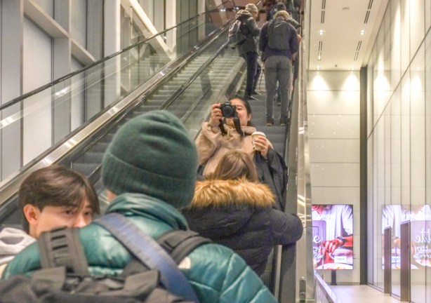 people on escalator inside CIBC building