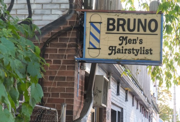 Bruno mens hairstylist sign on building on spadina