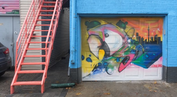 A parrot flies somewhere in Toronto - painted by Cruz.Uno