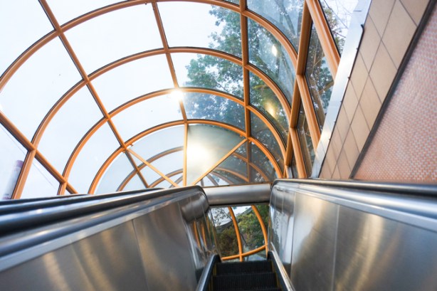 on escalator up to surface level, dupont subway station, looking towards glass dome roof of station entrance