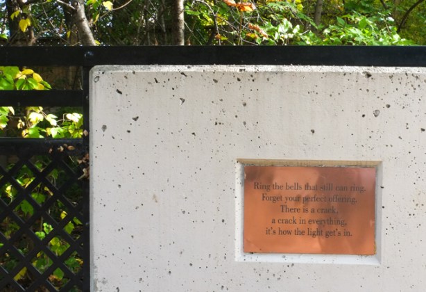 brass plaque embedded in the concrete of a bridge railing