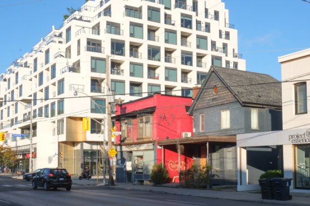old grey house, old brick building painted bright red, new condo development, in a line along dupont street